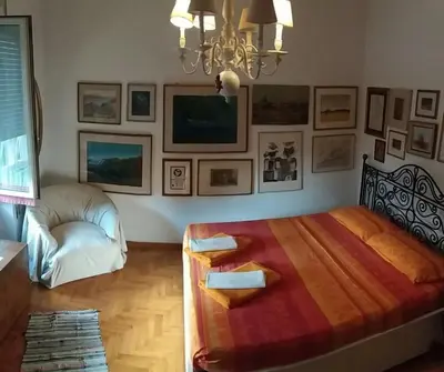 a bedroom with a large bed and a chandelier at Priscilla's inn in Rome