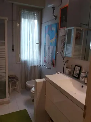 a bathroom with a sink and a toilet and a mirror at Priscilla's inn in Rome