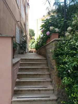 a stairway leading up to a building with flowers at Priscilla's inn in Rome