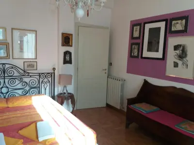 a bedroom with a bed and a chandelier at Priscilla's inn in Rome