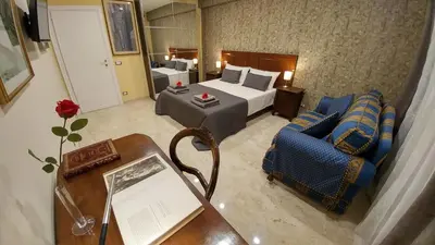 a hotel room with a bed and a table and chairs at Vatican69 New Apartment in Rome