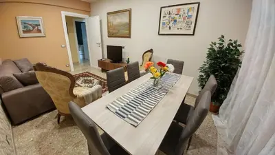 a living room with a table with flowers on it at Vatican69 New Apartment in Rome