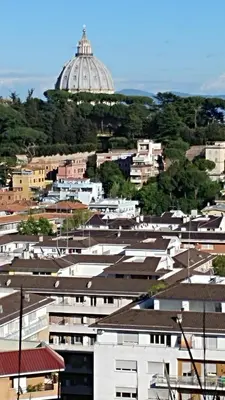 a city with buildings and a dome in the background at Vatican69 New Apartment in Rome