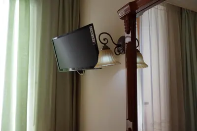 a tv on the wall of a hotel room at Hotel Filippo in Rome