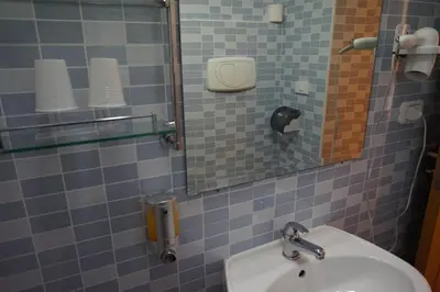 a bathroom with a sink and a mirror at Hotel Filippo in Rome