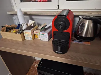 a red and black coffee maker sitting on a counter at St. Anthony Guest House in Rome