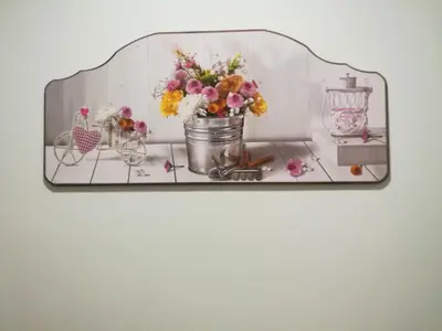 a glass shelf with a vase of flowers on it at St. Anthony Guest House in Rome