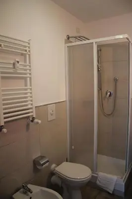 a bathroom with a shower and a toilet and a sink at St. Anthony Guest House in Rome
