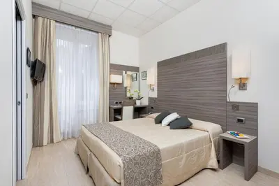 a hotel room with a bed and a desk at Morrisson Exclusive Rooms in Rome