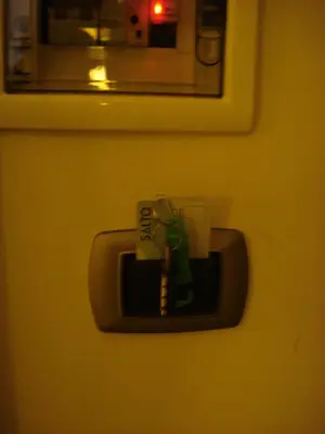 a key in a holder on a bathroom door at Morrisson Exclusive Rooms in Rome