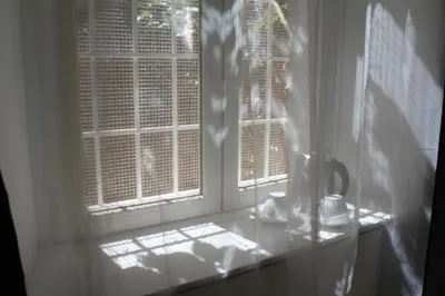a window in a room with two windows with blinds at Angolo di Roma Guest house in Rome