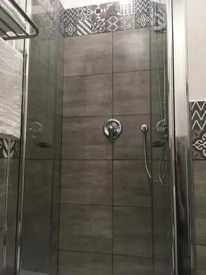 a shower with a glass door in a bathroom at Angolo di Roma Guest house in Rome