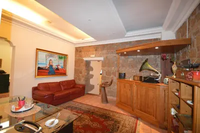 a living room with a couch and a table at Hotel Alexis in Rome