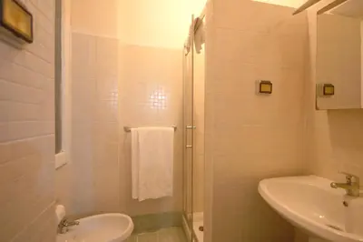 a white bathroom with a sink and a toilet at Hotel Alexis in Rome