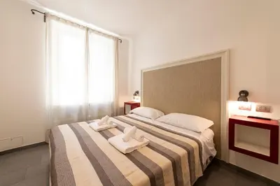 a bedroom with a large bed with towels on it at Guest House Al Conservatorio in Rome