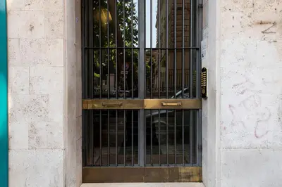 a gate on a building with a dog inside at Guest House Al Conservatorio in Rome