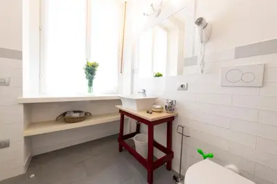 a bathroom with a sink and a toilet and a window at Guest House Al Conservatorio in Rome