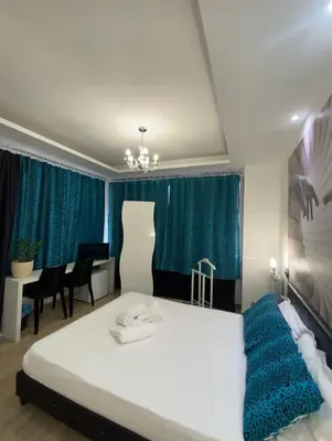 a bedroom with a large white bed and a table at Rome Sweet Home Vatican in Rome