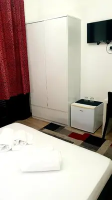 a room with a white bed and a cabinet at Rome Sweet Home Vatican in Rome