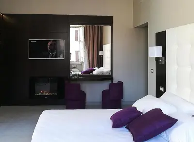 a hotel room with a bed and a mirror at Roman Holidays Boutique Hotel in Rome