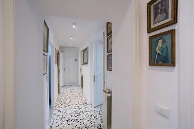 a hallway with paintings and pictures on the walls at Domus Aurea 295 in Rome