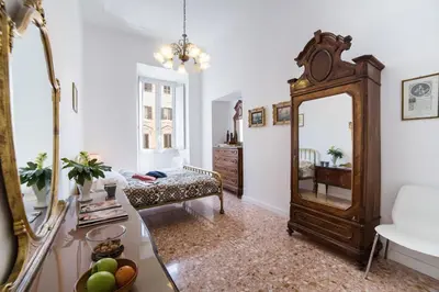 a living room with a mirror and a couch at Domus Aurea 295 in Rome