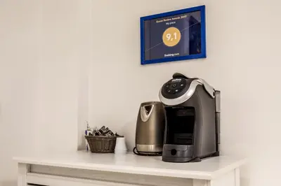 a coffeemaker sitting on a white counter top at Rome Vatican Rooms in Rome
