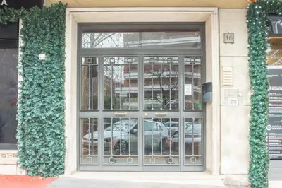 a glass door of a building with a car in it at Rome Vatican Rooms in Rome