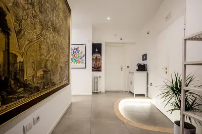 a room with a large painting on the wall and a hallway at Rome Vatican Rooms in Rome