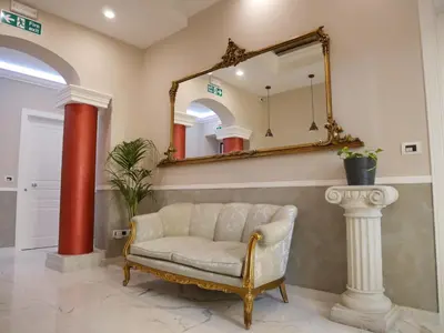 a living room with a couch and a mirror at Ann Inn in Rome