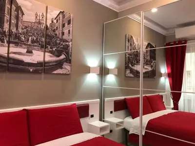 a bedroom with two beds with red pillows at Ann Inn in Rome