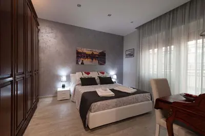 a bedroom with a large bed and a window at M&M House in Rome