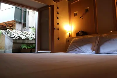 a bedroom with a bed and a window at Un Tetto al Pantheon in Rome