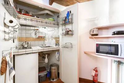 a small kitchen with a sink and a counter at Un Tetto al Pantheon in Rome
