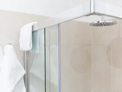 a shower with white towels and a glass shower stall at Venustas Roma Hotel in Rome