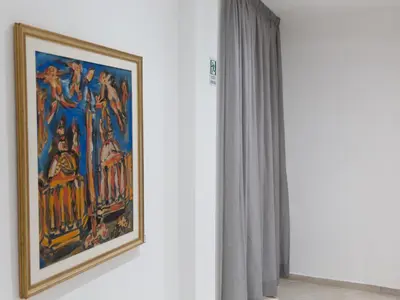 a painting hanging on a wall next to a window at Venustas Roma Hotel in Rome