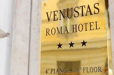 a sign for a roma hotel on a building at Venustas Roma Hotel in Rome