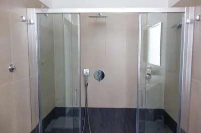 a shower with a glass door in a bathroom at Venustas Roma Hotel in Rome