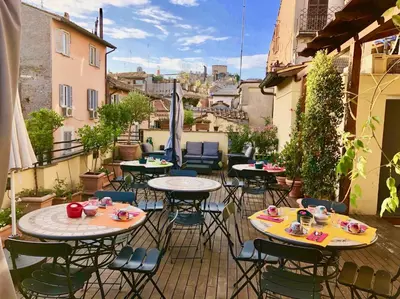 a group of tables and chairs on a patio at Navona Residenza de Charme in Rome