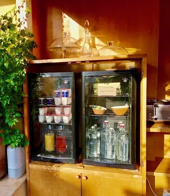 an open refrigerator in a kitchen with drinks at Navona Residenza de Charme in Rome