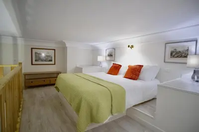 a bedroom with a bed with a green blanket at Navona Residenza de Charme in Rome