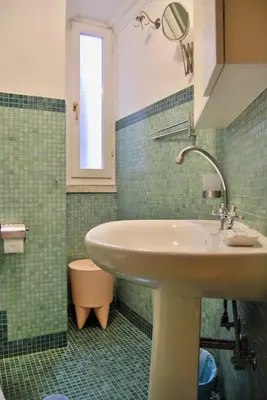 a bathroom with a sink and a mirror at Navona Residenza de Charme in Rome