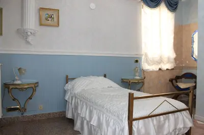a bedroom with a bed and a window at San Peter's Golden Rooms in Rome