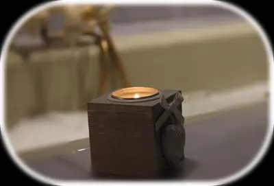 a candle sitting on top of a bath tub at San Peter's Golden Rooms in Rome