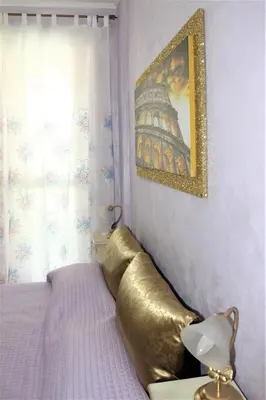 a bedroom with a bed with a large goldppelin at San Peter's Golden Rooms in Rome