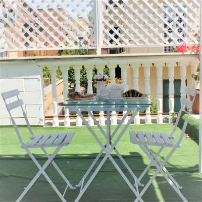 a blue table and two chairs on a patio at San Peter's Golden Rooms in Rome