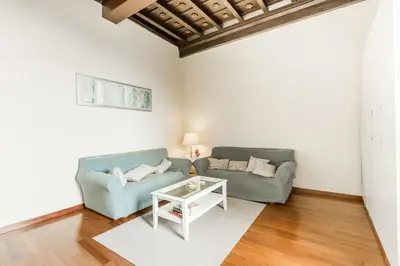 a living room with two couches and a table at Navona Bernini Lodge in Rome