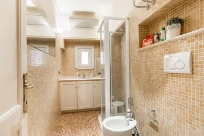 a bathroom with a toilet and a sink at Navona Bernini Lodge in Rome
