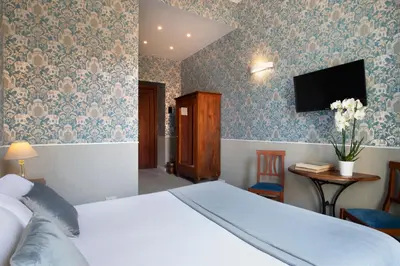 a bedroom with a bed and a tv on the wall at Welcome House in Rome