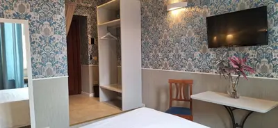 a room with a bed and a tv on the wall at Welcome House in Rome